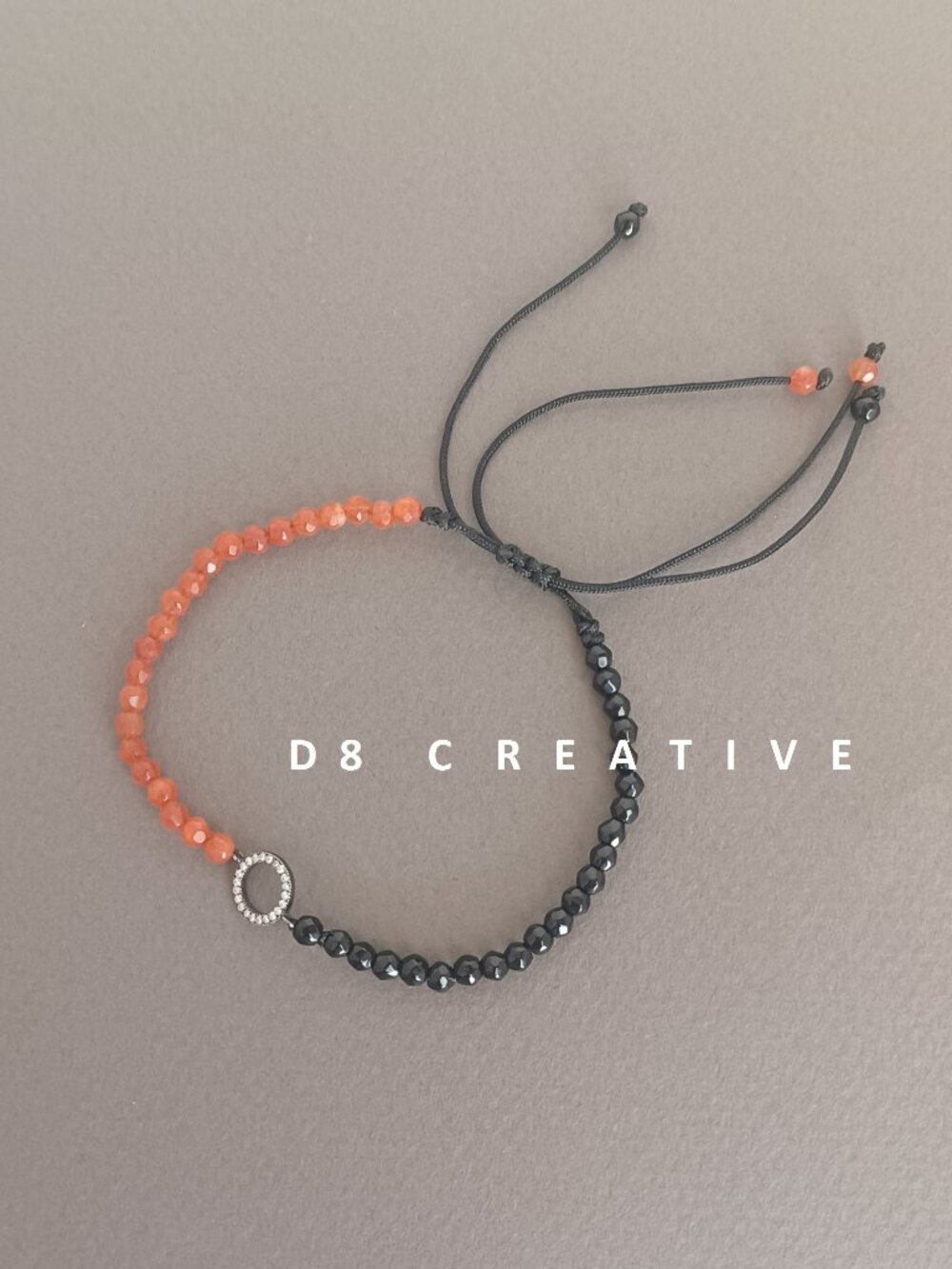 Hand woven orange agate with black onyx and sterling silver pendant bracelet